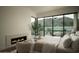 Inviting main bedroom featuring a modern fireplace and panoramic mountain views at 5327 N Invergordon Rd, Paradise Valley, AZ 85253