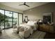 Serene main bedroom with a view of the backyard and comfortable seating area at 5327 N Invergordon Rd, Paradise Valley, AZ 85253