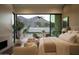 Cozy main bedroom with fireplace, and stunning views of the landscape at 5327 N Invergordon Rd, Paradise Valley, AZ 85253