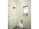 Modern shower featuring white vertical tile, glass door and window at 5327 N Invergordon Rd, Paradise Valley, AZ 85253