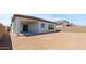 Backyard featuring a covered patio with a sliding glass door and a tall brown brick fence at 564 E Aurora Dr, San Tan Valley, AZ 85140
