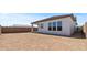 Backyard with a covered patio and a tall brown brick fence on a sunny day at 564 E Aurora Dr, San Tan Valley, AZ 85140