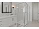 Bathroom featuring a glass shower with chrome fixtures, framed mirror, and white vanity sink at 564 E Aurora Dr, San Tan Valley, AZ 85140