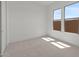 Neutral bedroom with plush carpeting and large windows offering bright natural light at 564 E Aurora Dr, San Tan Valley, AZ 85140