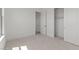Clean, minimalist bedroom with carpeting, closet, and neutral paint, ready for personalization at 564 E Aurora Dr, San Tan Valley, AZ 85140