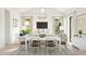Open concept dining area with white table and navy chairs at 564 E Aurora Dr, San Tan Valley, AZ 85140