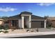 One-story home with brown and gray exterior, two-car garage, and desert landscaping at 564 E Aurora Dr, San Tan Valley, AZ 85140