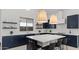 Well-appointed kitchen features a central island, modern pendant lighting and stainless steel appliances at 564 E Aurora Dr, San Tan Valley, AZ 85140