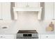 Modern range top with white cabinets and geometric backsplash at 564 E Aurora Dr, San Tan Valley, AZ 85140