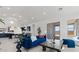 Open-concept living room flows into the kitchen and dining area, with a blue sofa and modern decor at 564 E Aurora Dr, San Tan Valley, AZ 85140