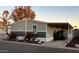 Single-wide manufactured home with covered carport and landscaping at 625 W Mckellips Rd # 7, Mesa, AZ 85201