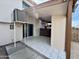 Covered patio with sliding glass door and modern white marble tile flooring at 7117 W Wolf St, Phoenix, AZ 85033