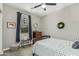 Bedroom with carpet flooring, gray walls, ceiling fan and a large window for lots of natural light at 7564 W Darrel Rd, Laveen, AZ 85339