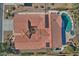 An aerial view showcasing a home with a red tile roof, pool, and solar panels at 7850 W Discovery Way, Florence, AZ 85132