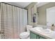 Bathroom with teal vanity, shower, and a patterned shower curtain at 8500 E Southern Ave # 577, Mesa, AZ 85209