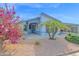 Brightly colored home with flowering plants and a covered carport at 8500 E Southern Ave # 577, Mesa, AZ 85209