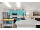 Bright teal kitchen features stainless steel appliances and an island at 8500 E Southern Ave # 577, Mesa, AZ 85209