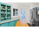 Modern kitchen with teal cabinets, stainless steel appliances, and an island at 8500 E Southern Ave # 577, Mesa, AZ 85209