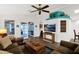 Living room with wood-look floors, comfy seating and view into sunroom at 8500 E Southern Ave # 577, Mesa, AZ 85209