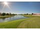 Expansive golf course featuring serene lake, well-manicured greens, and clear blue sky at 8909 E Hercules Ct, Sun Lakes, AZ 85248