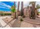 The side of a single-story home with desert landscaping and a partial view of the three-car garage at 8909 E Hercules Ct, Sun Lakes, AZ 85248