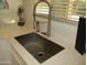 Modern kitchen sink and faucet with quartz countertops at 9827 W Lindgren Ave, Sun City, AZ 85373