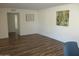 Living room with light wood laminate flooring and art at 9827 W Lindgren Ave, Sun City, AZ 85373