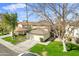 Two-story house with attached garage and grassy front yard at 10024 W Montecito Ave, Phoenix, AZ 85037