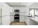 Modern kitchen with white cabinets and stainless steel appliances at 10024 W Montecito Ave, Phoenix, AZ 85037