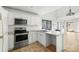 Modern kitchen with white cabinets and stainless steel appliances at 10024 W Montecito Ave, Phoenix, AZ 85037