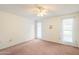 Bedroom features neutral carpet, ceiling fan, and bright natural light at 10329 W Manzanita Dr, Sun City, AZ 85373