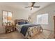 Bright bedroom with a ceiling fan and ensuite bathroom at 11057 W Tonto Ln, Peoria, AZ 85373