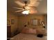 Comfortable primary bedroom featuring a large bed, ceiling fan, ensuite bath and closet at 11411 N 91St Ave # 225, Peoria, AZ 85345
