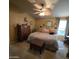 Comfortable primary bedroom featuring a large bed, ceiling fan, ensuite bath and closet at 11411 N 91St Ave # 225, Peoria, AZ 85345