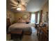 Comfortable primary bedroom featuring a large bed, ceiling fan, ensuite bath and closet at 11411 N 91St Ave # 225, Peoria, AZ 85345