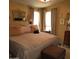Comfortable primary bedroom featuring a large bed, ceiling fan, ensuite bath and closet at 11411 N 91St Ave # 225, Peoria, AZ 85345