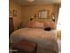 Spacious primary bedroom featuring a large bed, fan, ensuite bath and closet at 11411 N 91St Ave # 225, Peoria, AZ 85345