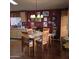 Warm dining room features a wooden table, six chairs, and accent lighting at 11411 N 91St Ave # 225, Peoria, AZ 85345