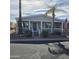 Inviting single-story home featuring a cozy front porch, a palm tree, and an attached covered carport at 11411 N 91St Ave # 225, Peoria, AZ 85345