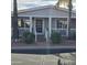 Close up view of a home with a front porch and adorned with shrubs and brick steps at 11411 N 91St Ave # 225, Peoria, AZ 85345