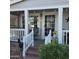 Inviting front porch with a covered seating area, white railings, and decorative accents at 11411 N 91St Ave # 225, Peoria, AZ 85345