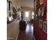 Hallway with hardwood floors and walls adorned with many picture frames, adding character and charm at 11411 N 91St Ave # 225, Peoria, AZ 85345