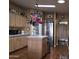 Spacious kitchen featuring wood floors, a central island, stainless steel refrigerator, and ample cabinet space at 11411 N 91St Ave # 225, Peoria, AZ 85345