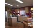 Cozy kitchen featuring stainless steel appliances, a center island, and warm-toned cabinetry at 11411 N 91St Ave # 225, Peoria, AZ 85345
