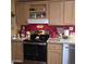 Kitchen featuring stainless steel appliances, wooden cabinets, and rooster-themed decor, creating a warm, country-style ambiance at 11411 N 91St Ave # 225, Peoria, AZ 85345