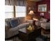 Comfortable living room featuring a neutral sofa, armchair with ottoman, and a dark wood coffee table at 11411 N 91St Ave # 225, Peoria, AZ 85345