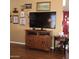 Living room with a large television on a wooden entertainment center and laminate floors at 11411 N 91St Ave # 225, Peoria, AZ 85345
