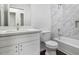 Bathroom with white vanity, marble walls, and a bathtub at 1238 S 14Th St, Phoenix, AZ 85034