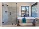 Spa-like bathroom featuring a soaking tub and a frameless glass shower at 1326 E Clearwater Ln, Gilbert, AZ 85234