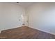 Spacious bedroom with wood-look floors and an open door to hallway at 1326 E Clearwater Ln, Gilbert, AZ 85234